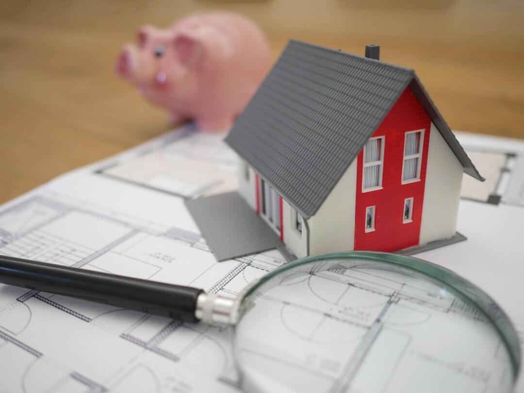Model house on architectural blueprints representing estate planning